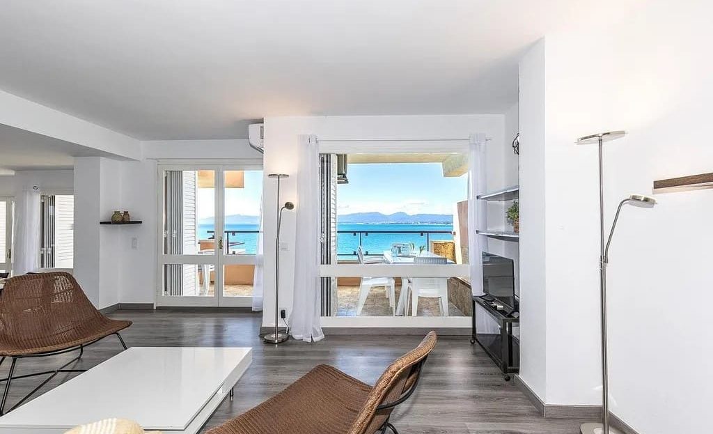 Просторная гостиная с большими окнами и прямым выходом на террасу с видом на море.