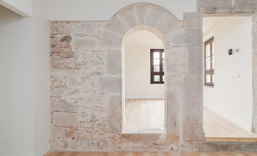 Оригинальная каменная арка и окна с деревянными рамами