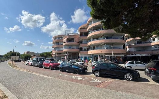 Фасад жилого здания в Плайя-larga рядом с парковкой и соснами