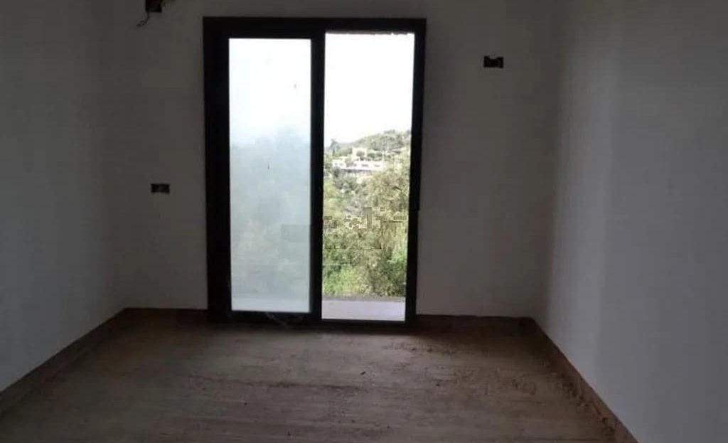 Пустая комната с большими окнами и видом на природу, дом под отделку.