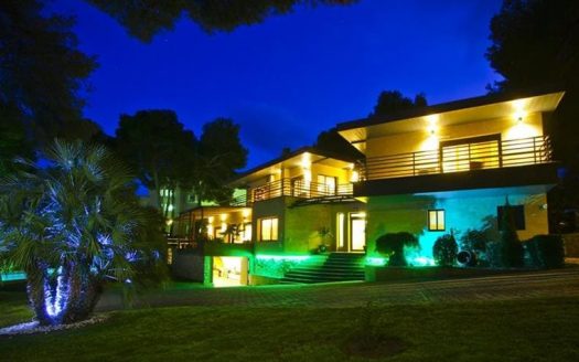 Ночной вид виллы и сада с декоративной подсветкой