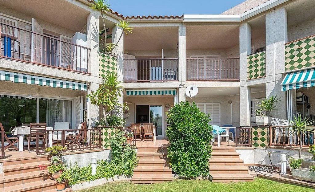 Фасад таунхауса в жилом комплексе с балконами и садом