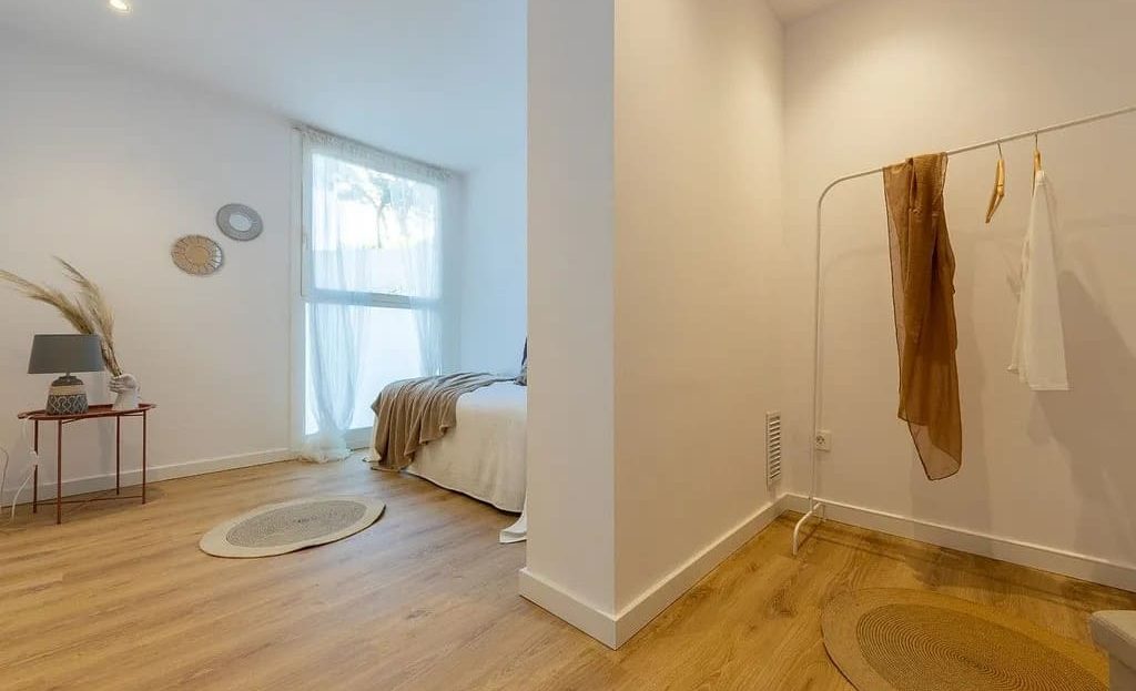 Светлая спальня с большим окном и минималистичным декором