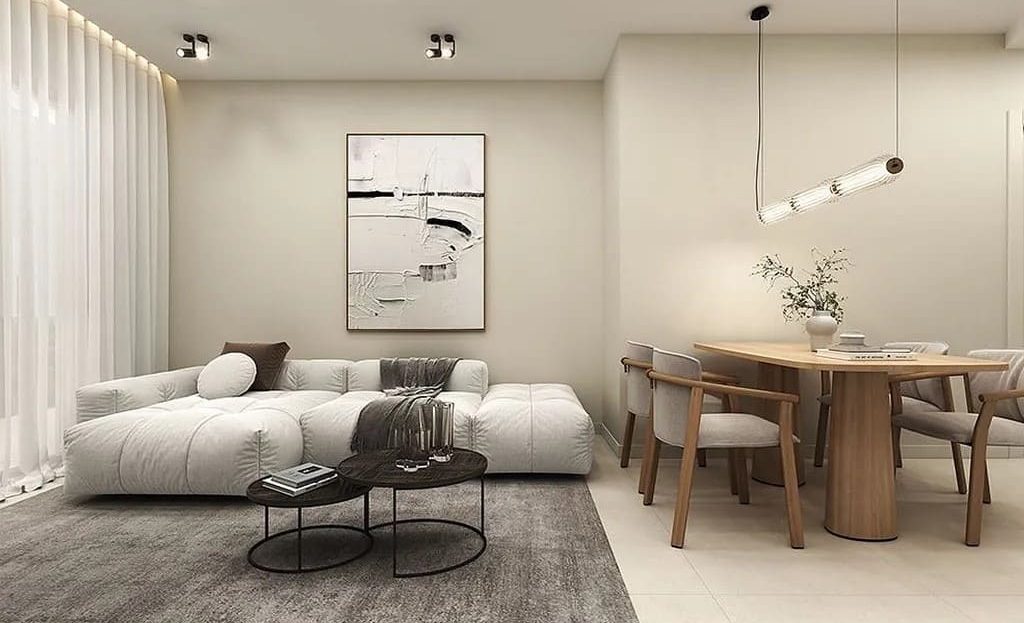 Гостиная-столовая с минималистичным интерьером и естественным освещением.