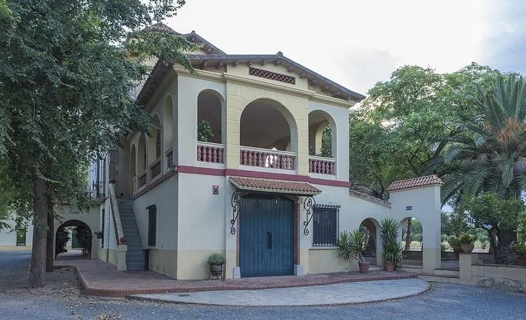 Главный вход поместья с балконами и декоративной архитектурой