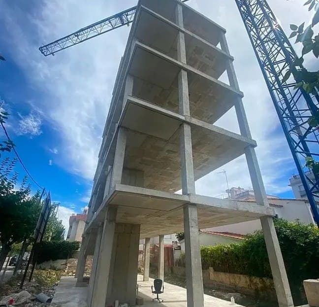 Фото строительной площадки с несколькими уровнями незавершённой конструкции.