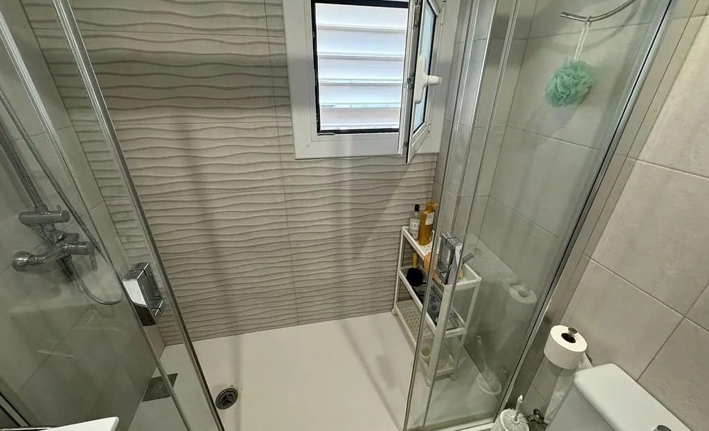 Ванная комната с душевой кабиной и санузлом.