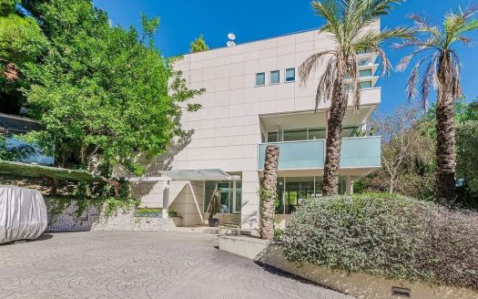 Современный фасад элитного дома в Педральбес с гаражом и ландшафтным дизайном.